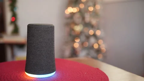 Generic Smart Home Assistant Lighting Up in Front of Christmas Tree 스톡 동영상 166920528