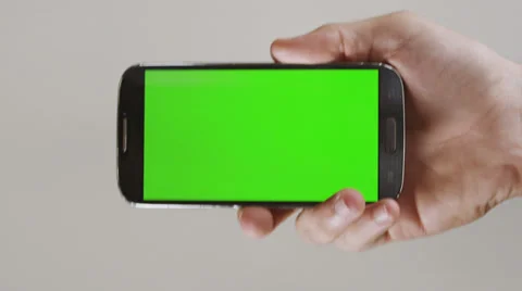 Generic smarth phone without a logo enters the screen by a hand. Stock Footage 30418246