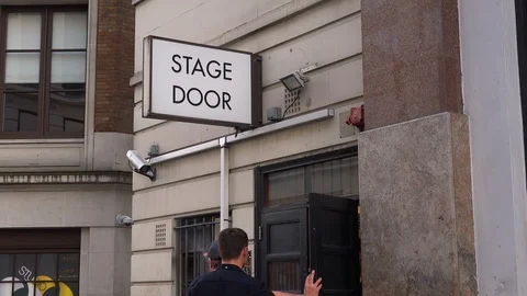 A generic stage door leads actors and performers to the backstage of a local 库存影片 107444546