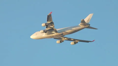 Generic Unmarked 747 Type Jumbo Airliner Flying in a Golden Hour Blue Sky Stock Footage 246751332
