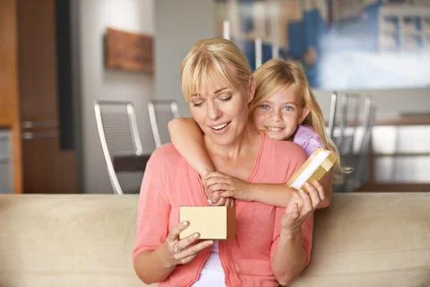 The generosity of spirit. a young girl giving her mother a gift. Stock Photos