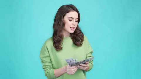 Generous lady count money throw air isolated aquamarine color background Stock Footage 169943289