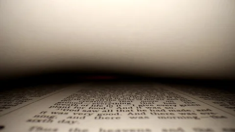 GENESIS-Quickly pushing lens into a book &amp;then slowly gliding, a words eye Stock Footage 111288373