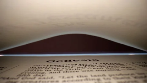 GENESIS-Slowly pulling lens out of book, center view of the page. Words Stock Footage 111288334