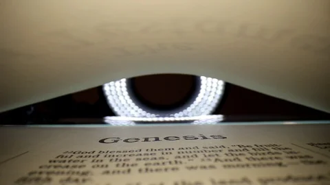 GENESIS-Slowly pulling lens out of book, center view of the page. Words Stock Footage 111288583