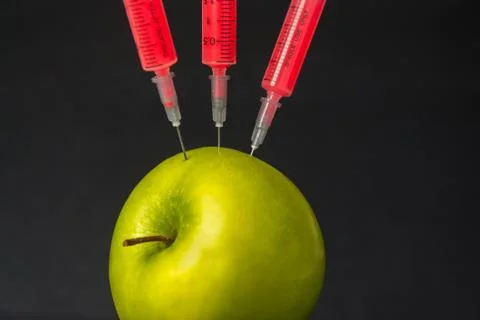 Genetic manipulation with an apple Stock Photos