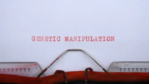 Genetic manipulation - phrase printed on an old typewriter in red letters Stock Footage 128399633