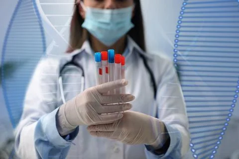 Genetic testing. Laboratory worker with test tubes and illustration of DNA .. Stock Photos