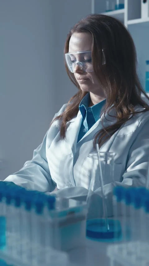 A geneticist scientist using a computer and a microscope studies the structure Stock Footage 272653173