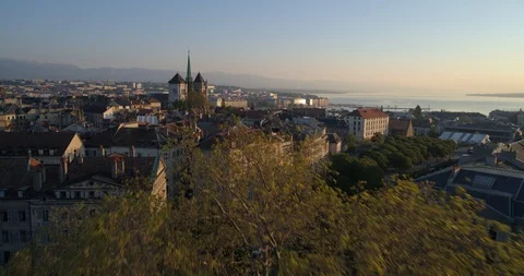 Geneva cathedral appearing behind trees - Aerial 4K Stock Footage 108317842