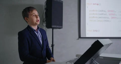 Genius Schoolboy In Classic Jacket Speaking In Classroom, Presenting Computer Stock Footage 280174077