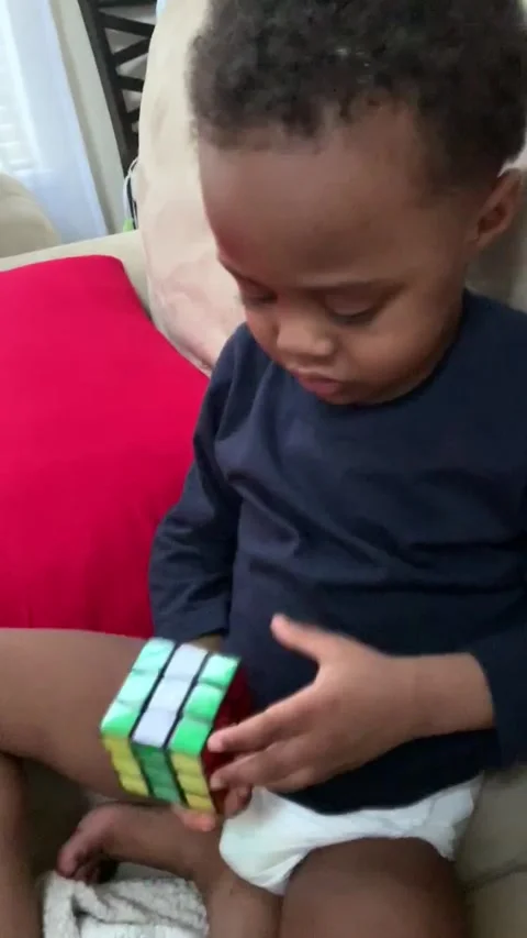 Genius three-year-old boy solves his first Rubik's Cube Stock Footage 272971597