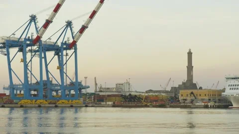 Genoa lighthouse Lanterna and port cranes at dawn, Italy 動画素材 335634662