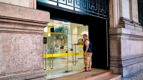 Genoa - A man is entering the Post Office Video stock 114636054