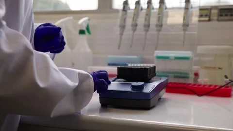 Genomics Lab -  Arranging small test tubes to mix Stock Footage 272155684