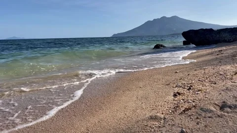 Gentle Beach Waves With Mountain View in Tropical Coastline Stock Footage 334985926