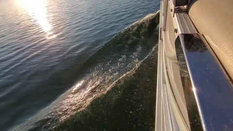 Gentle boat wake with sun reflection 스톡 동영상 219635052