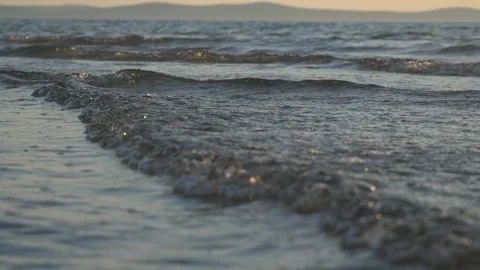 Gentle calm ocean waves washing softly over wet shore sand Stock Footage 337410314