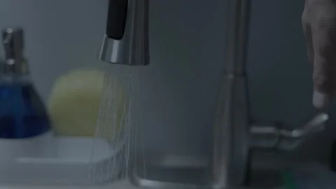 Gentle Cascade: Slow Motion Unveiling of Kitchen Faucet Elegance Stock Footage 257293170
