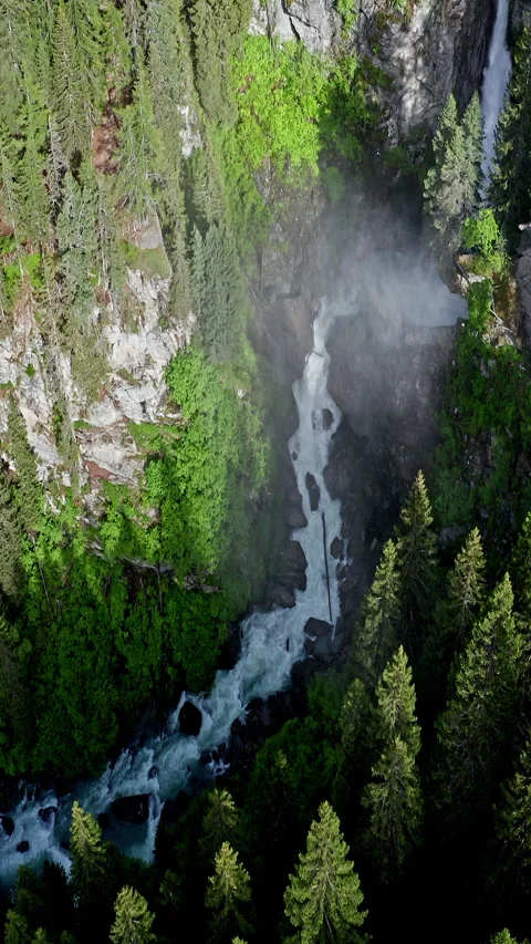 Gentle Cascade of a Vertical Waterfall in a Mountainous Region Видео 334772949