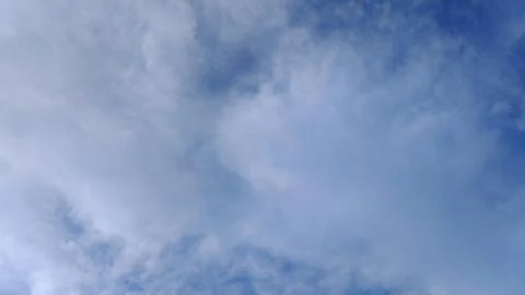 Gentle Cloud Patterns in Soft Blue Sky Stock Photos