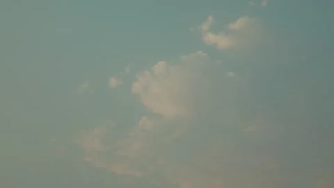 Gentle clouds drifting across a clear blue sky. Peaceful nature background Vidéo 336647718
