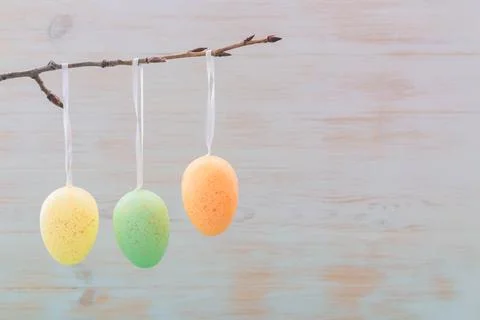 Gentle colorful easter eggs on tree branch on vintage wood background Stock Photos