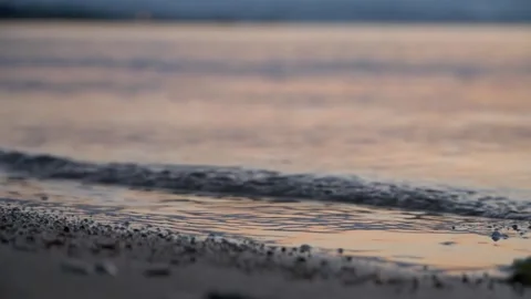 Gentle evening ocean waves washing softly onto a sandy beach. Stock Footage 337406572