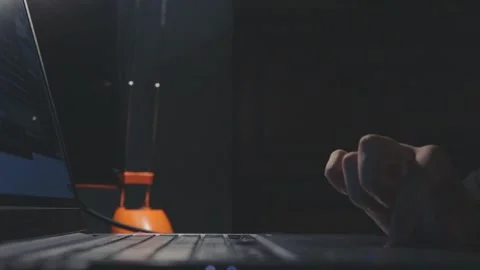 Gentle finger using touchpad on laptop computer pressing keyboard buttons in dar Stock Footage 161038171