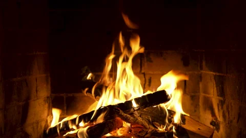 Gentle Flames Flicker and Sway in a Rustic Brick Fireplace Stock Footage 335381385