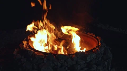 Gentle flames flicker around stone circle at night Stock Footage 323724030