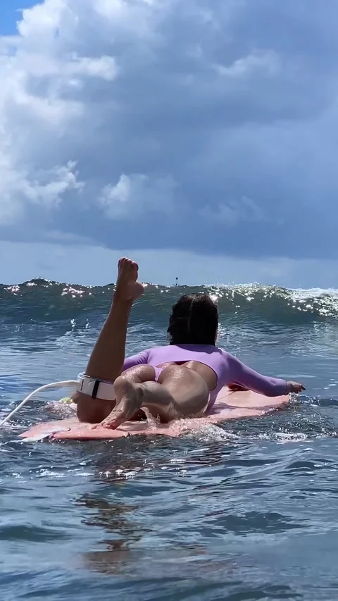 Gentle Float On Surfboard Amid Expansive Ocean And Cloudy Sky Stock Footage 328395418