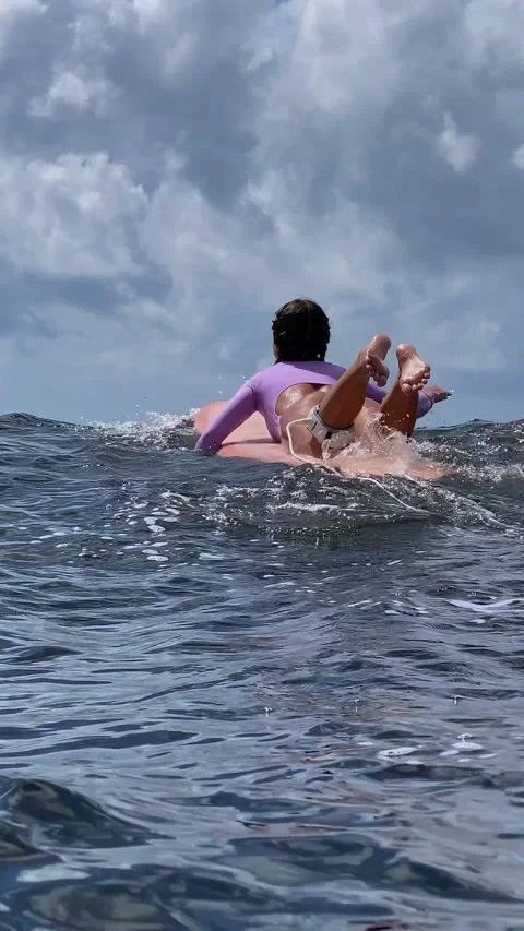 Gentle Float On Surfboard Amid Expansive Ocean And Cloudy Sky Stock Footage 328395434