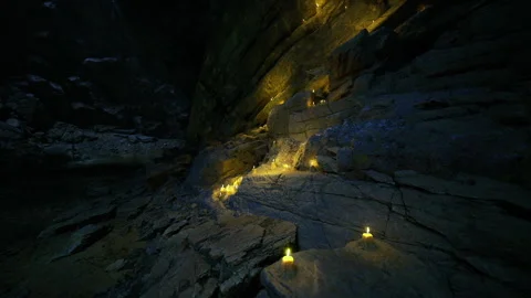 Gentle illumination casts shadows in ancient underground cavern Stock Footage 343621200