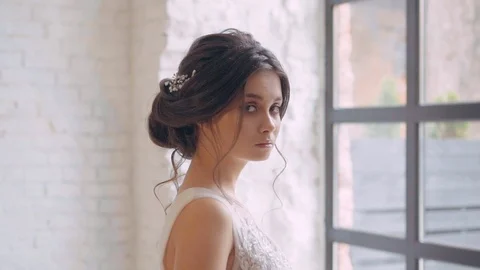 Gentle image of the bride, innocent sweet girl in a long white expensive luxury Stock Footage 100193383