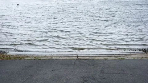 Gentle Lake Waves Lapping Against Concrete Boat Launch Stock Footage 346489231