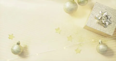 Gentle light waves rippling over holiday tabletop, causing ornaments, gift box, Stock Footage 319360865