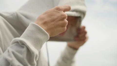 Gentle man observes cloudy sky, Man with hoodie watches over cloudy weather Stock Footage 327273946