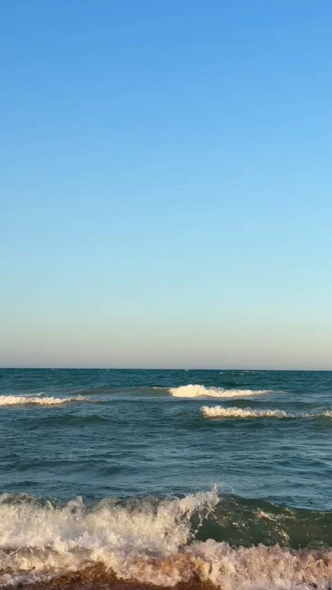 Gentle Mediterranean sea waves lapping on the shore in Gandia, Spain Stock Footage 342646253