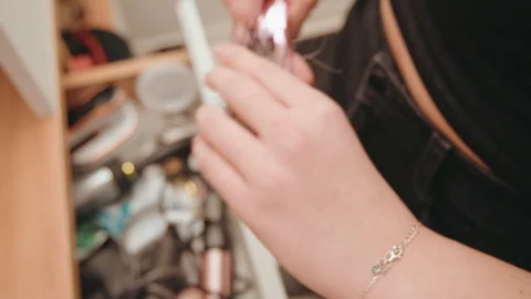 Gentle movements clear makeup brushes in morning routine. Casual woman tidies Stock Footage 337451401