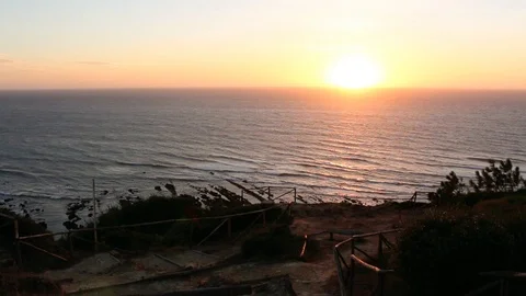 Gentle Ocean waves during the sunset, seen from a rustic viewpoint in Cabo Stock Footage 110757340