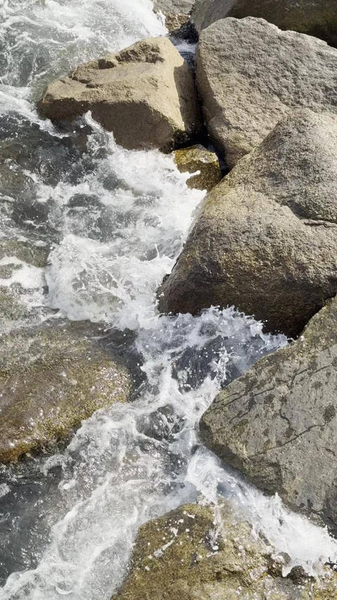 Gentle Ocean Waves Lapping Against Coastal Rocks Stock Footage 306762281