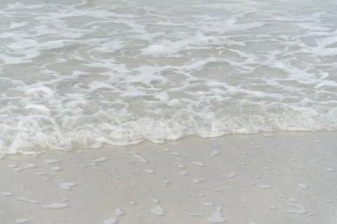 Gentle Ocean Waves Lapping on Soft Sandy Shoreline in a Calm Seascape with .. Stock Photos