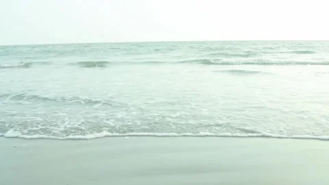 Gentle Ocean Waves Lapping Softly on Sandy Shore under Bright Sky Stock Footage 239171062