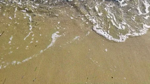 Gentle Ocean Waves Lapping Softly onto a Wet Sandy Beach Shoreline Stock Footage 346848450