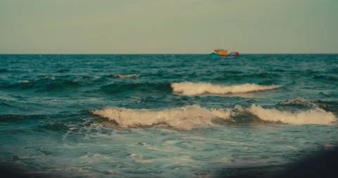 Gentle ocean waves rolling and crashing onto a sandy beach shore. Stock Footage 342469944