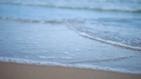 Gentle ocean waves rolling onto a sandy beach, creating a soothing coastal .. 스톡 동영상 293124228