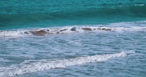 Gentle ocean waves rolling onto sandy beach shore Stock Footage 339519789