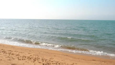 Gentle Ocean Waves Rolling Onto Sandy Beach Under A Bright Clear Summer Sky Stock-Footage 342258908