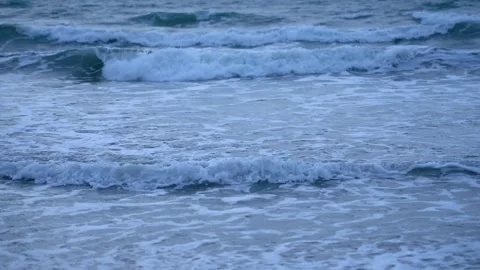 Gentle Ocean Waves Rolling Towards The Sandy Shoreline During A Calm Summer Day Video stock 342025192